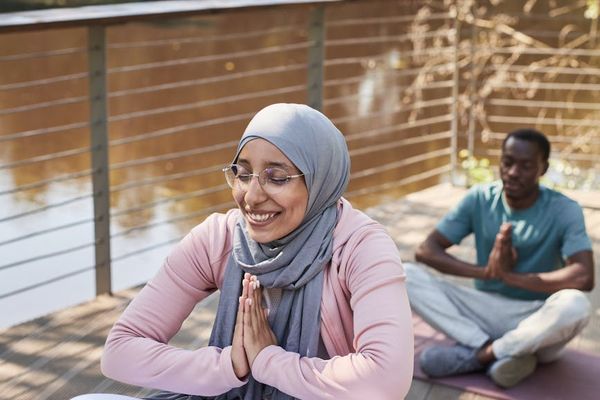People sitting in a circle, meditating and connecting in a yoga community.