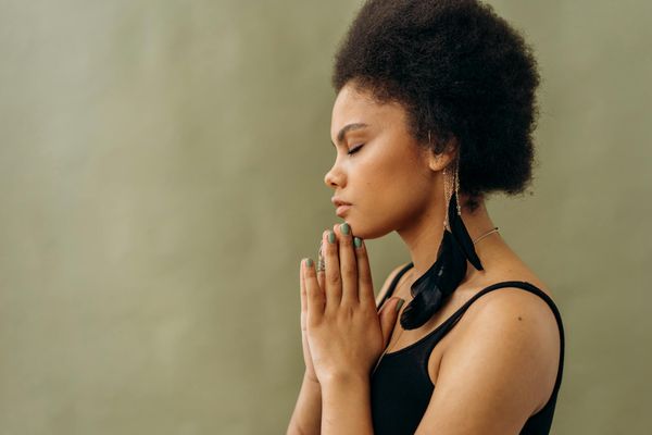 Woman in a peaceful yoga pose, focused on her breath and inner calm.